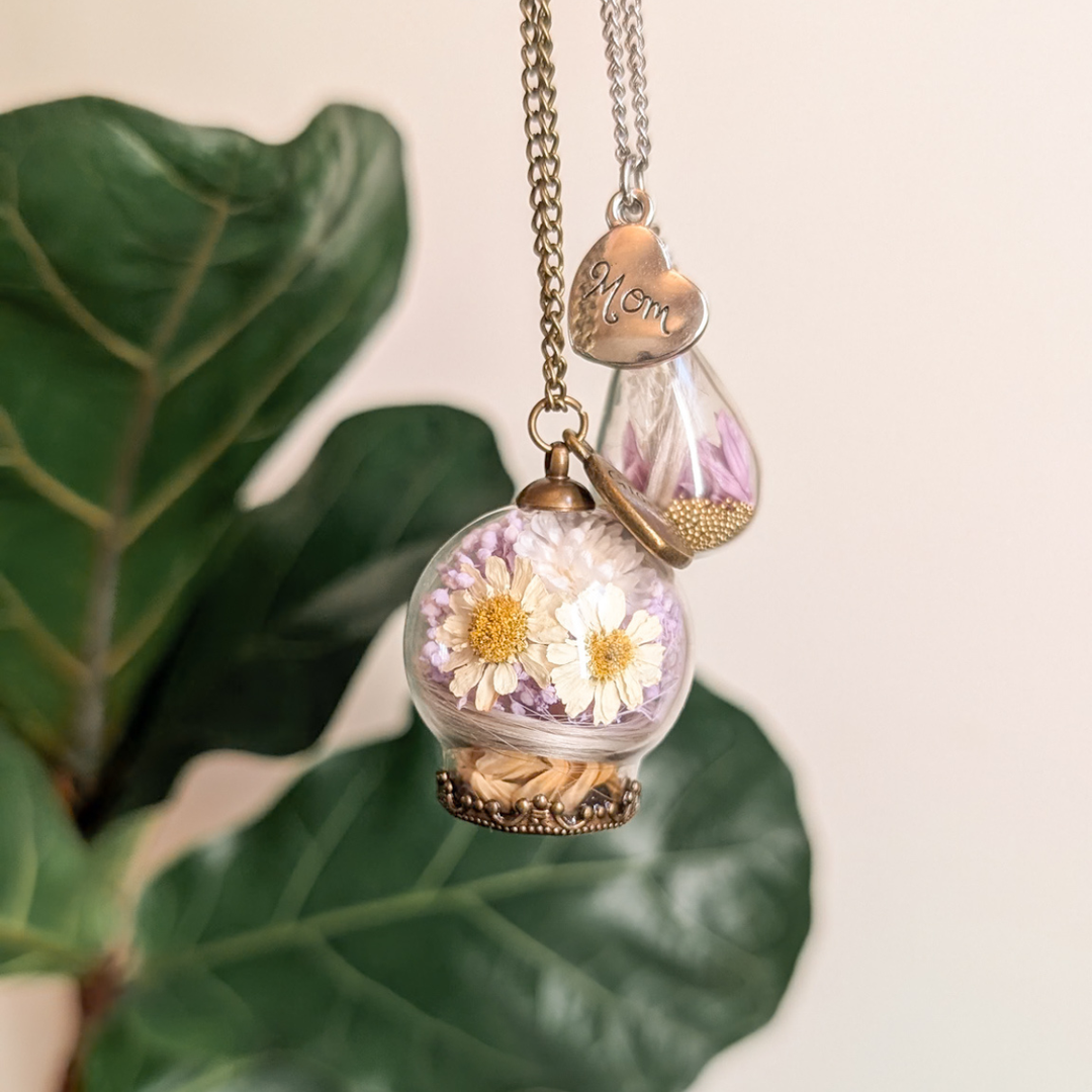 Pendentif boule de verre avec une mèche de cheveux blancs, marguerites, fleurs lilas et une breloque cœur Mom pour maman